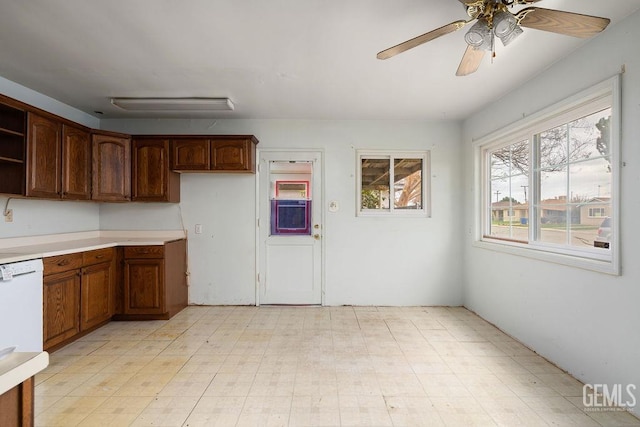 kitchen with a ceiling fan, open shelves, light countertops, and light floors