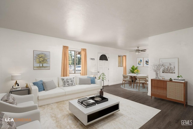 living room with wood finished floors, baseboards, and a ceiling fan