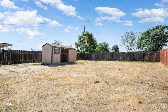 fenced backyard with a shed and an outbuilding