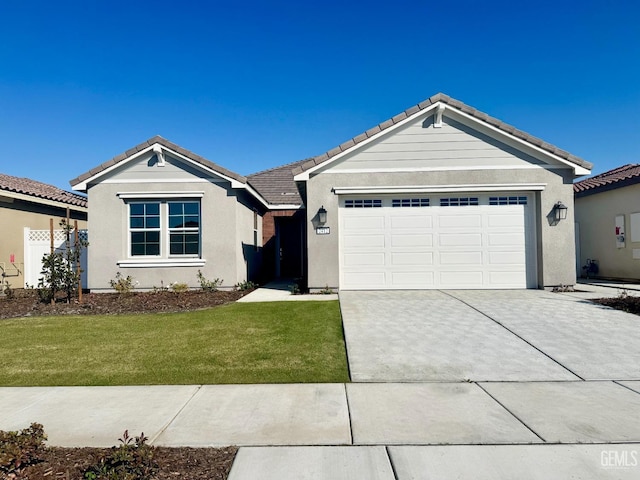 single story home featuring a garage and a front lawn