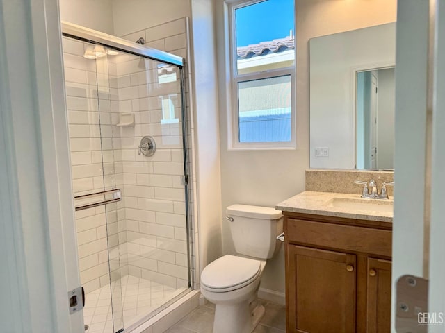 bathroom featuring tile patterned flooring, walk in shower, vanity, and toilet