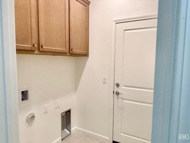 washroom featuring light tile patterned flooring, cabinets, hookup for a washing machine, and electric dryer hookup