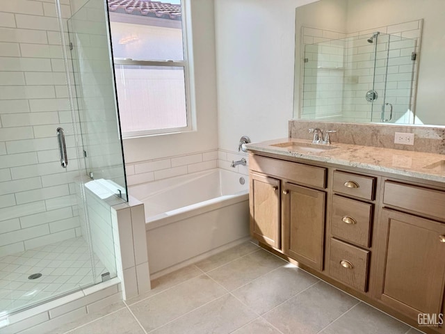 bathroom featuring independent shower and bath, vanity, and tile patterned floors