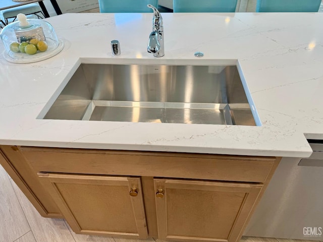 room details featuring light stone counters and sink