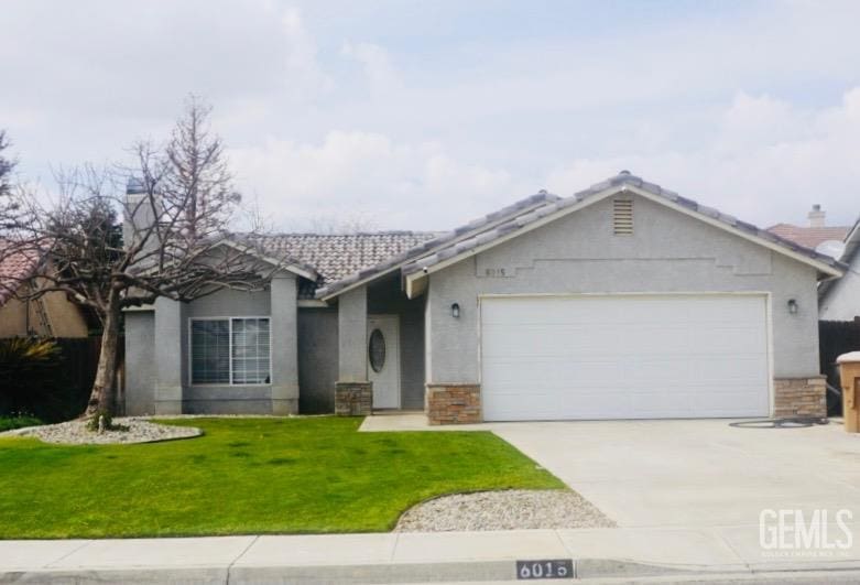 ranch-style house featuring a garage and a front yard