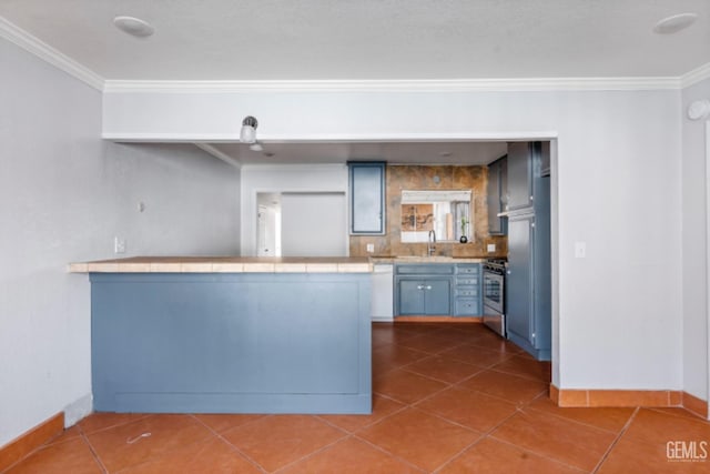 kitchen featuring tile patterned floors, kitchen peninsula, ornamental molding, and stainless steel range