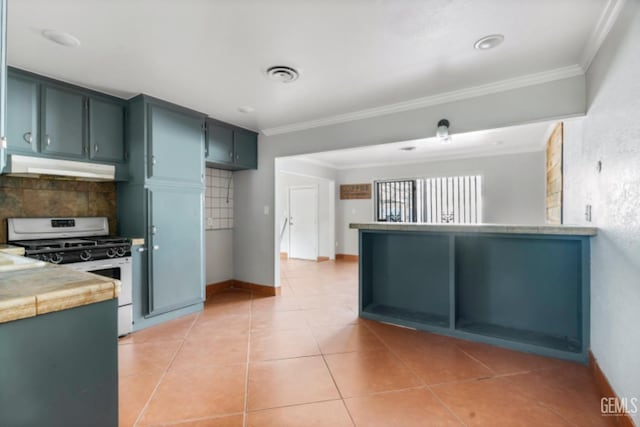 kitchen with light tile patterned floors, tasteful backsplash, white gas range, and ornamental molding