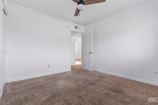 carpeted spare room featuring ceiling fan and crown molding