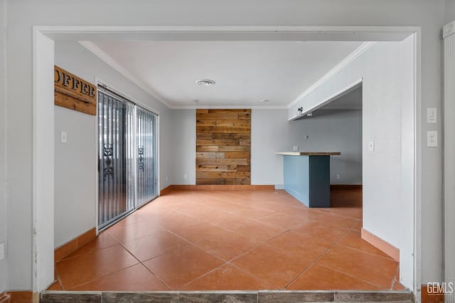 spare room featuring crown molding and tile patterned flooring