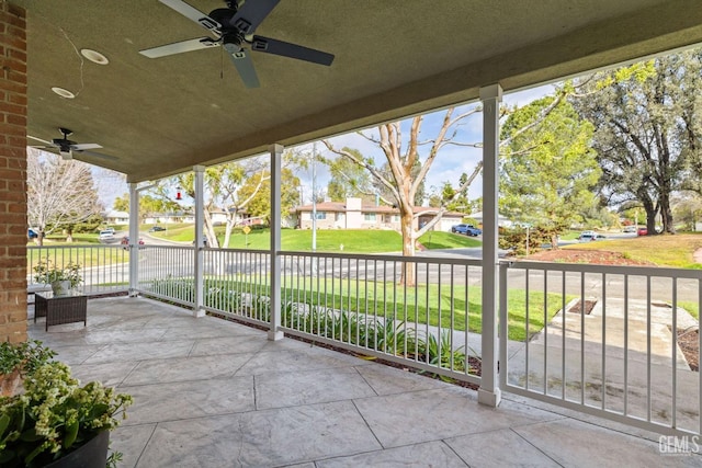 view of patio / terrace with a ceiling fan and a residential view