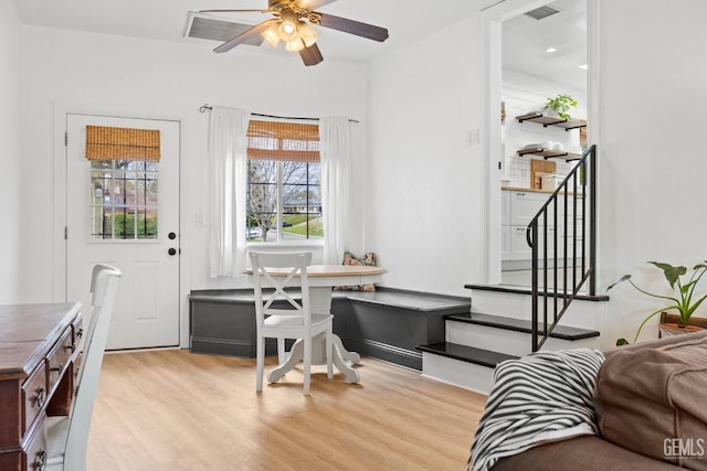 interior space with visible vents, a ceiling fan, and light wood-style floors