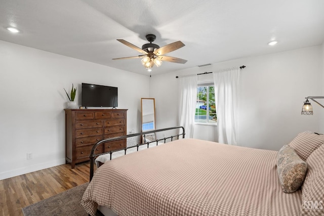 bedroom with visible vents, baseboards, recessed lighting, wood finished floors, and a ceiling fan