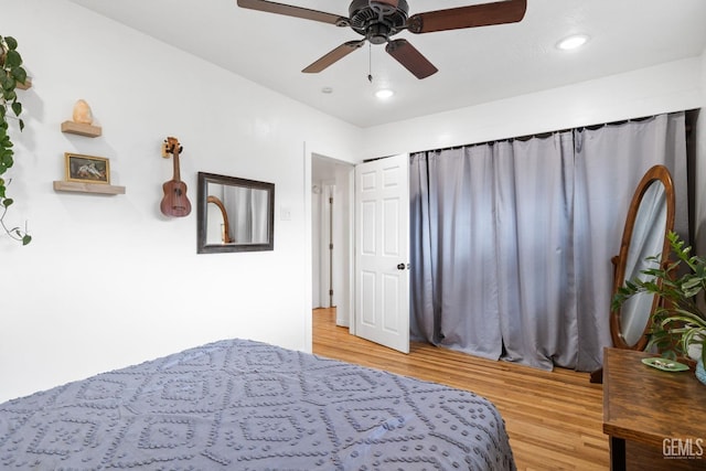 bedroom with a ceiling fan, recessed lighting, and wood finished floors