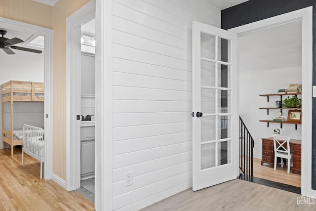 corridor with french doors and wood finished floors