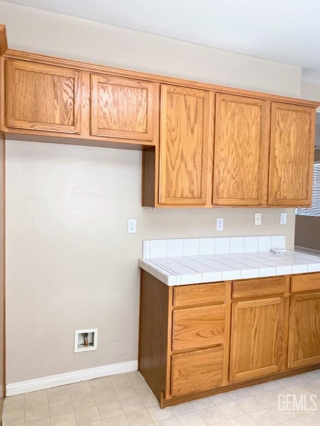 6622 Rimridge Way, Bakersfield, CA 93313 - kitchen featuring light countertops and brown cabinets