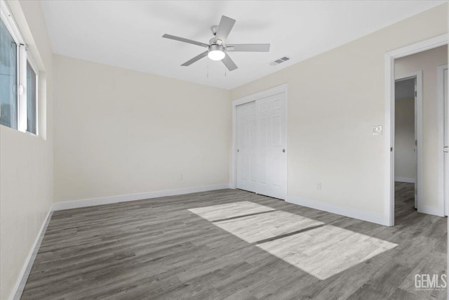 empty room featuring ceiling fan and wood-type flooring