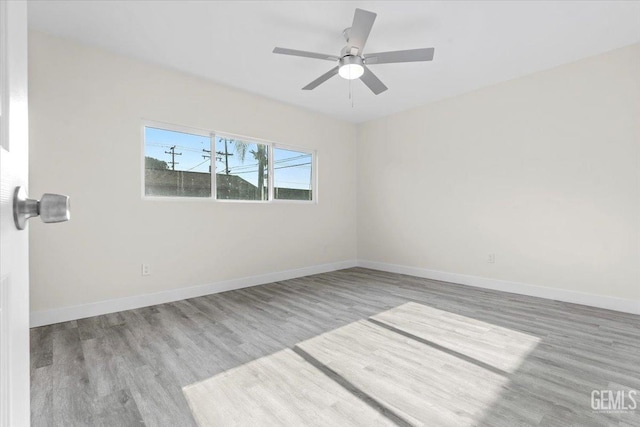 empty room with ceiling fan and light wood-type flooring