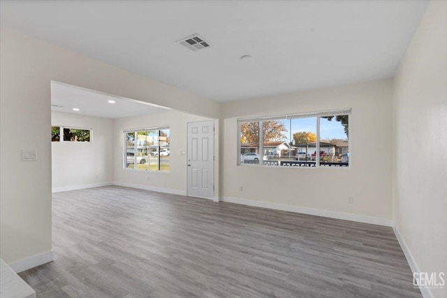 unfurnished room with hardwood / wood-style floors