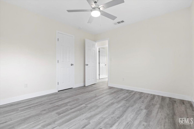 spare room featuring light hardwood / wood-style flooring and ceiling fan