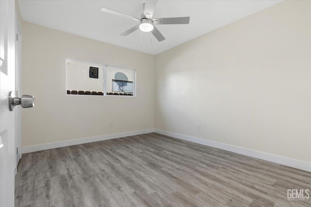 spare room featuring ceiling fan and light wood-type flooring