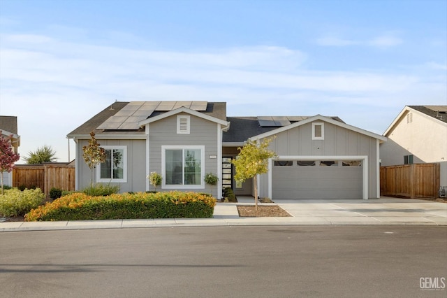 view of front of home featuring solar panels and a garage