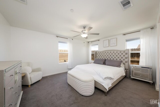 6028 Bogart Dr, Bakersfield, CA 93313 - bedroom with multiple windows, dark colored carpet, a ceiling fan, and baseboards