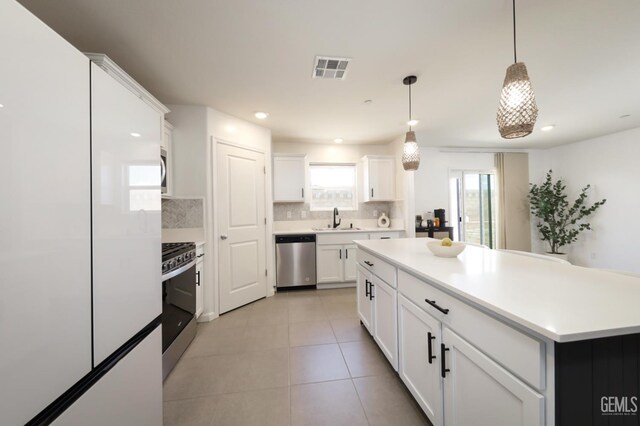 6028 Bogart Dr, Bakersfield, CA 93313 - kitchen featuring appliances with stainless steel finishes, a sink, tasteful backsplash, plenty of natural light, and recessed lighting