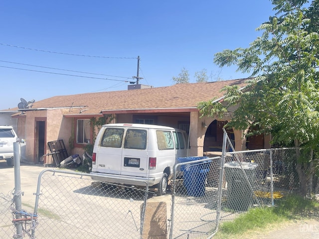 1105 Vansite St, Bakersfield, CA 93307 - ranch-style home with a gate, a shingled roof, and stucco siding