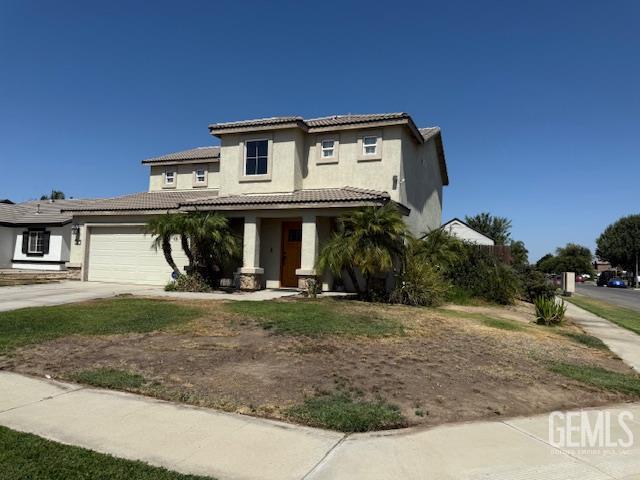302 Quaking Aspen Ave, Wasco, CA 93280 - view of front of house featuring stucco siding, covered porch, an attached garage, concrete driveway, and a tiled roof