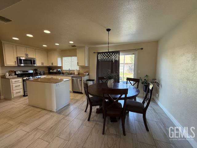 302 Quaking Aspen Ave, Wasco, CA 93280 - kitchen featuring stainless steel appliances, plenty of natural light, white cabinets, and recessed lighting