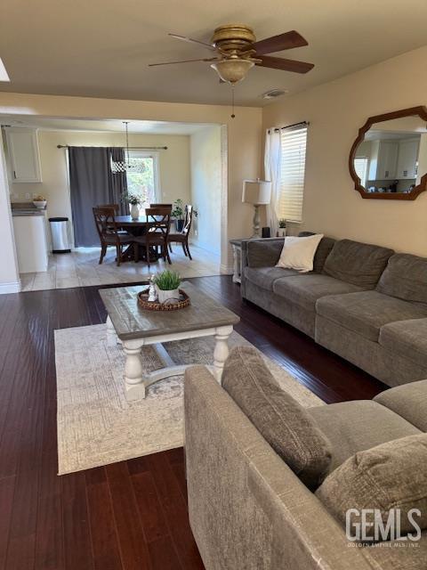302 Quaking Aspen Ave, Wasco, CA 93280 - living room featuring a ceiling fan, wood finished floors, and a chandelier