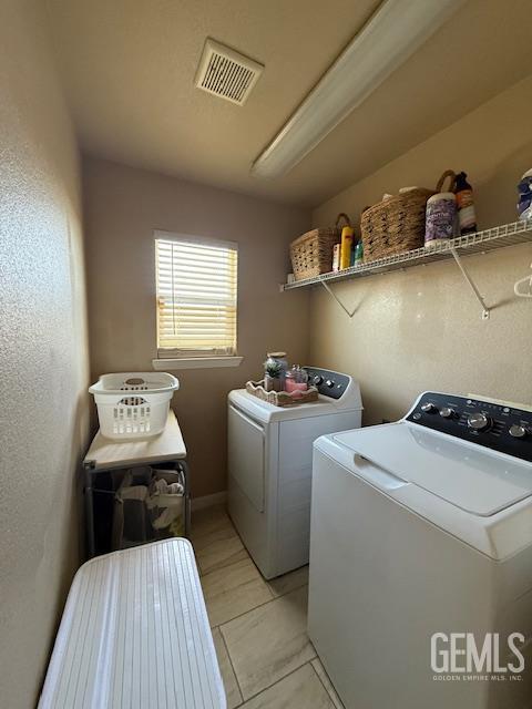 302 Quaking Aspen Ave, Wasco, CA 93280 - laundry room featuring washer and dryer and light tile patterned floors