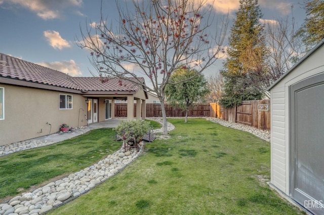 yard at dusk with a patio