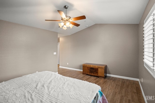 bedroom with hardwood / wood-style floors, vaulted ceiling, and ceiling fan