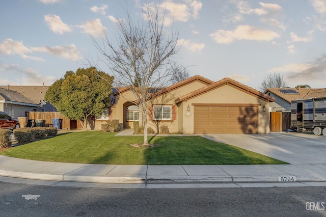 view of front of house with a front yard and a garage