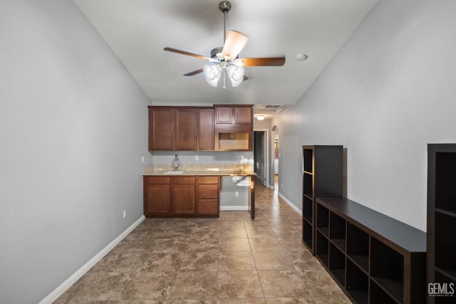 kitchen featuring tile patterned floors, ceiling fan, and sink