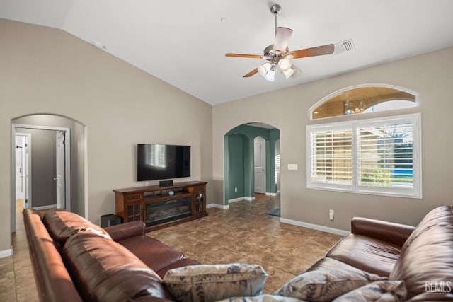 tiled living room featuring ceiling fan and vaulted ceiling