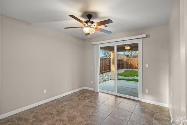 tiled empty room with ceiling fan