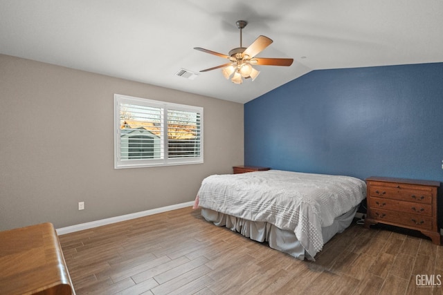 bedroom featuring hardwood / wood-style floors, ceiling fan, and lofted ceiling