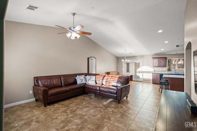 living room with ceiling fan with notable chandelier and lofted ceiling