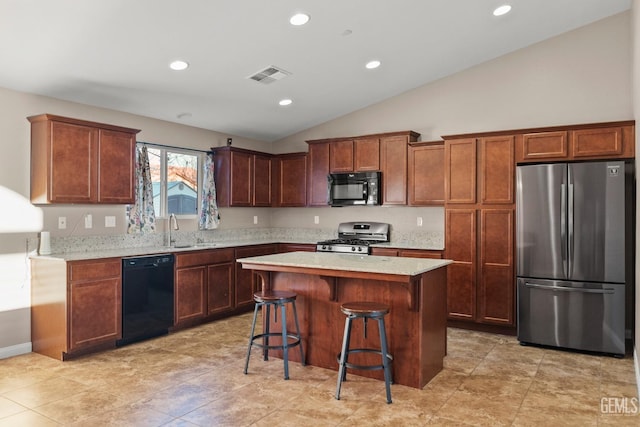 kitchen featuring sink, a kitchen breakfast bar, vaulted ceiling, a kitchen island, and black appliances