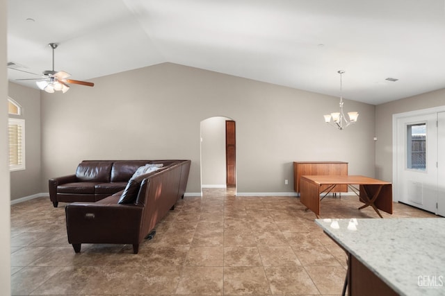 living room featuring ceiling fan with notable chandelier and vaulted ceiling