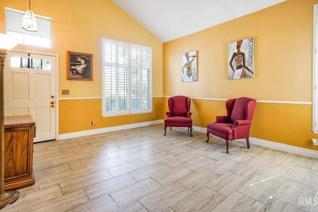 sitting room featuring vaulted ceiling, wood finish floors, and baseboards