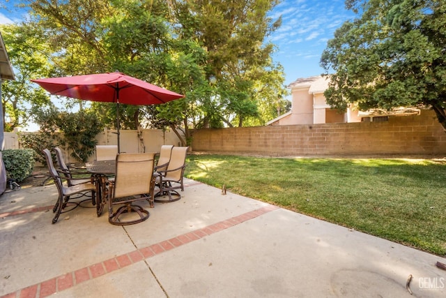 view of patio featuring outdoor dining area and fence