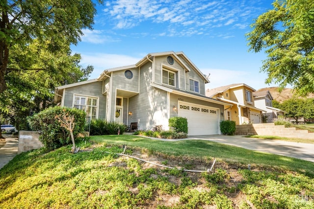 traditional-style home with a garage, concrete driveway, and a front yard