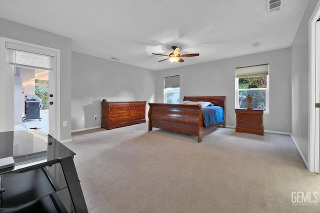 bedroom featuring ceiling fan, access to exterior, and light carpet