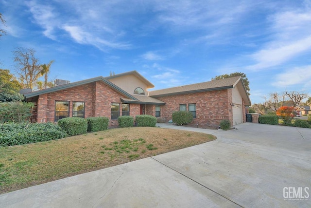 view of front of property with a front yard and a garage