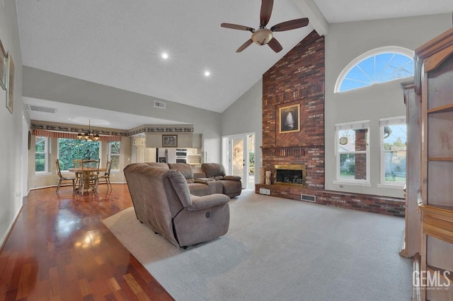 living room with high vaulted ceiling, beam ceiling, ceiling fan, and a fireplace