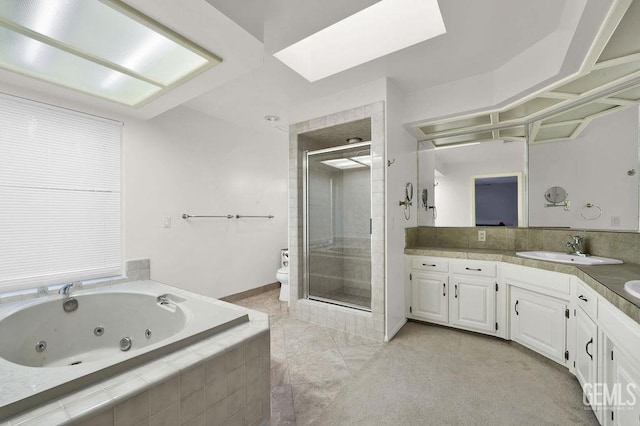 full bathroom featuring toilet, vanity, a skylight, and shower with separate bathtub