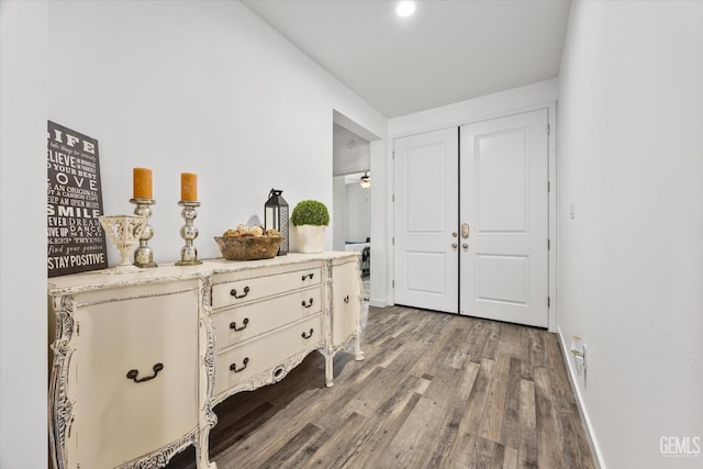 hall with wood finished floors and baseboards